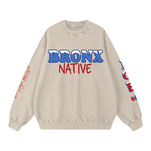 Beige sweatshirt with 'Bronx Native' text in blue and red on a white background