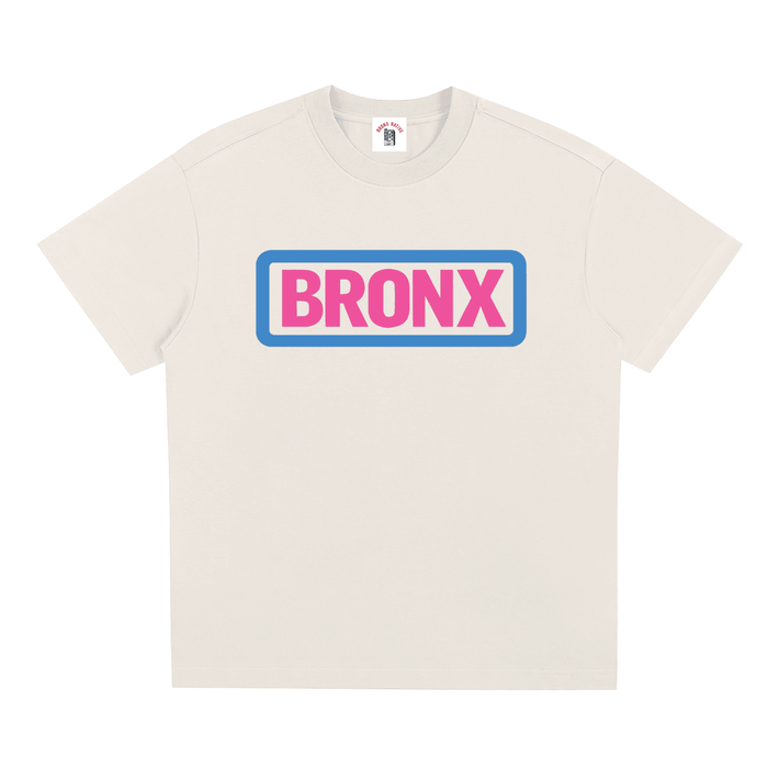 Cream Bronx t-shirt with bold pink 'BRONX' text in blue border, NYC streetwear style