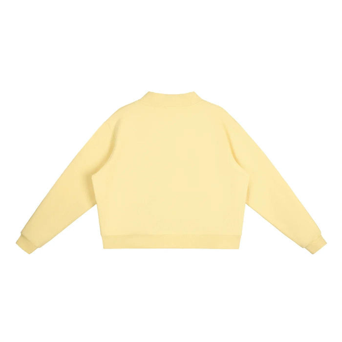 Pale yellow cropped sweatshirt with long sleeves, back view, minimalist streetwear style