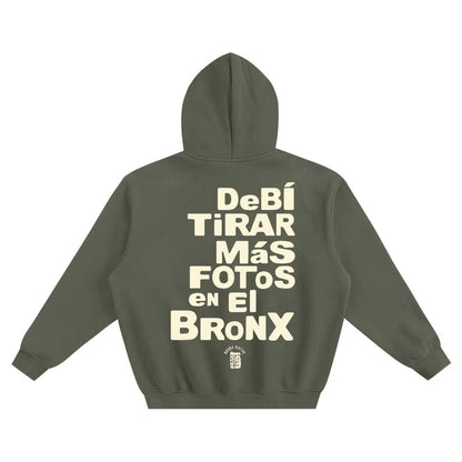 Olive green hoodie with 'Debí Tirar Más Fotos en El Bronx' text, NYC streetwear style